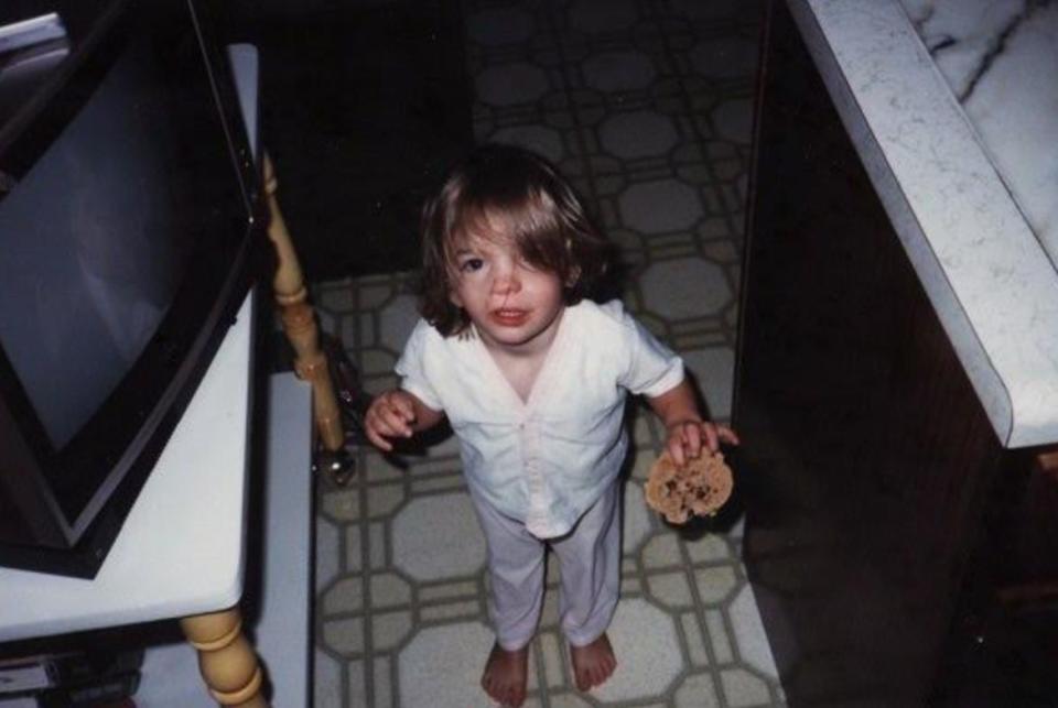 The author at age 3 in 1986. "I have always loved to eat, despite the challenges my birth anomalies have created for me in that area. This is a normal-sized cookie I am holding; I was born small." (Photo: Courtesy of Kristin Pfeifauf)