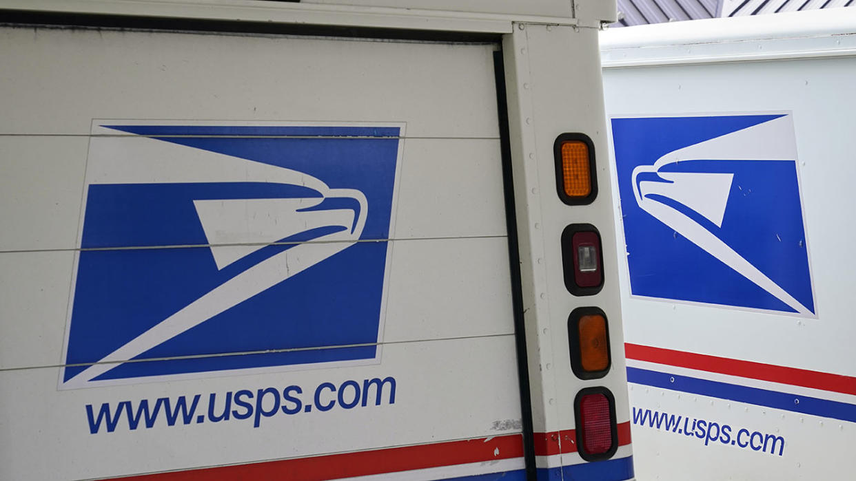 Postal service trucks. (Nati Harnik/AP)