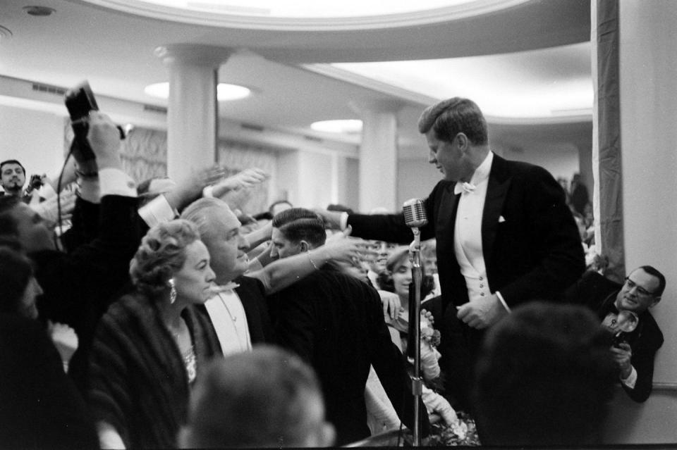 <p>After arriving at his inaugural ball, JFK greets his supporters and gives a few remarks to the hoards of ticket holders who came to celebrate. This comes a mere hours after his<a href="https://www.jfklibrary.org/asset-viewer/archives/USG/USG-01-12/USG-01-12" rel="nofollow noopener" target="_blank" data-ylk="slk:historic inaugural address;elm:context_link;itc:0;sec:content-canvas" class="link "> historic inaugural address</a>, where he stated, "Ask not what your country can do you for—ask what you can do for your country."</p>