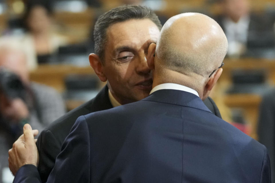 Serbia's new Prime Minister Milos Vucevic, front, speaks with Aleksandar Vulin, former director of Serbia's intelligence agency, who has fostered close ties with Russia and is sanctioned by the United States at the parliament session during the cabinet's swearing in ceremony at the Serbian Parliament building in Belgrade, Serbia, Thursday, May 2, 2024. Serbian lawmakers on Thursday voted into office a new government that reinstated two pro-Russia officials who are sanctioned by the United States, reflecting persistent close ties with Moscow despite the Balkan nation's proclaimed bid to join the European Union. (AP Photo/Darko Vojinovic)