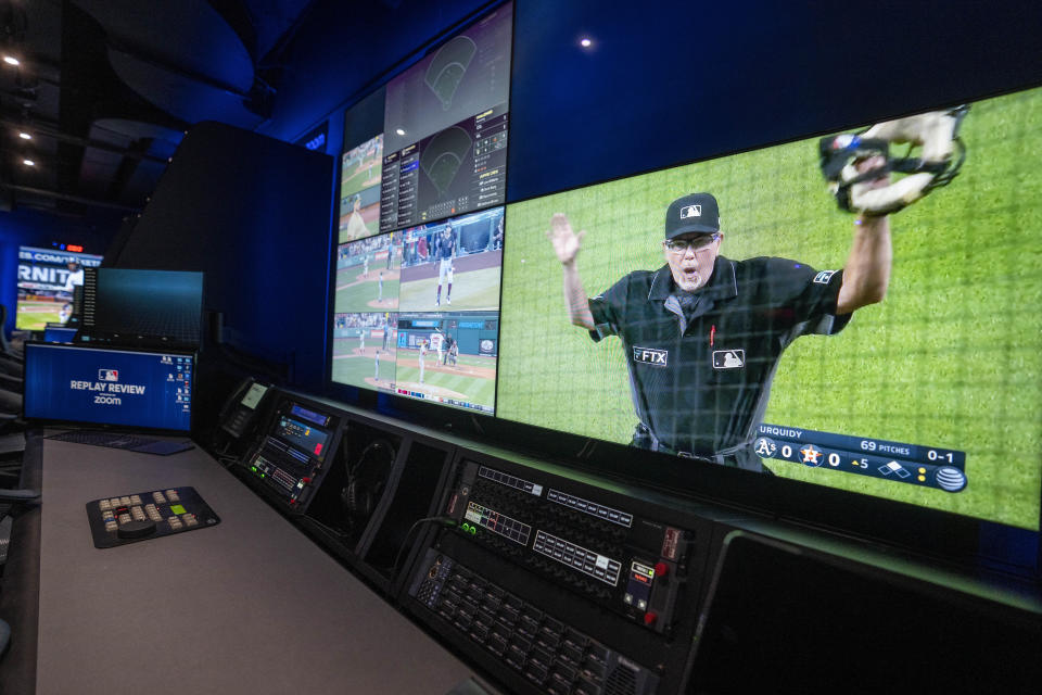 A Major League Baseball umpire is displayed alongside gameplay clips during a tour of a Replay Review station at MLB headquarters in New York, Tuesday, March 28, 2023. (AP Photo/John Minchillo)