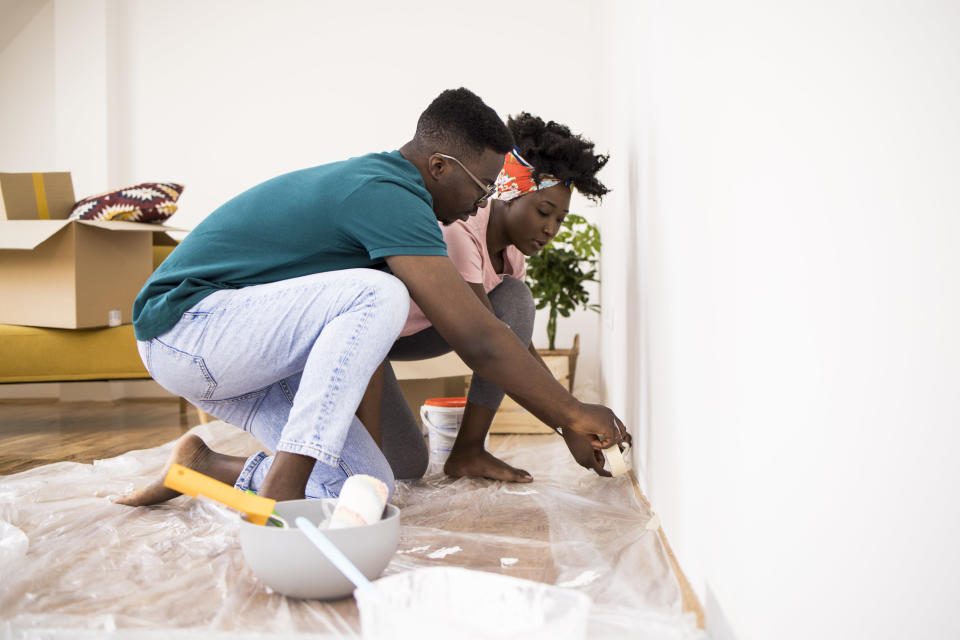 a couple painting a room