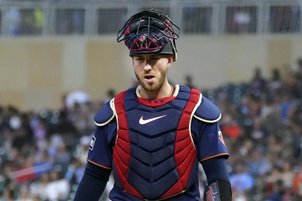 FILE - Minnesota Twins' Mitch Garver catches against the Cleveland Indians in a baseball game, on Aug. 17, 2021, in Minneapolis. The Texas Rangers have traded Isiah Kiner-Falefa, their starting shortstop last season supplanted by the blockbuster addition of Corey Seager, to the Minnesota Twins for catcher Mitch Garver. (AP Photo/Jim Mone, FIle)