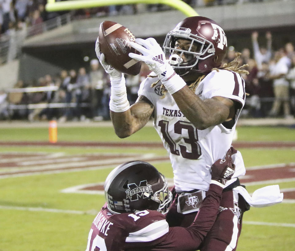 Texas A&M wide receiver Kendrick Rogers (13) attempts to catch a pass as Mississippi State safety Stephen Adegoke (19) defends during the first half of their NCAA college football game on Saturday, Oct. 27, 2018, in Starkville, Miss. The pass to Rogers was ruled incomplete.(AP Photo/Jim Lytle)