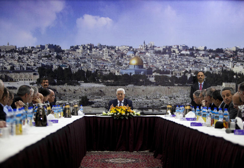 Palestinian President Mahmoud Abbas talks during a leadership meeting in Ramallah, Tuesday, April 1, 2014. In a dramatic move that could derail eight months of U.S. peace efforts, President Abbas resumed a Palestinian bid for further U.N. recognition despite a promise to suspend such efforts during nine months of negotiations with Israel. Abbas signed "State of Palestine" applications for 15 U.N. agencies in a hastily convened ceremony after Israel calls off a promised prisoner release. (AP Photo/Majdi Mohammed)