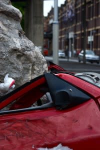 Car crushed by boulder