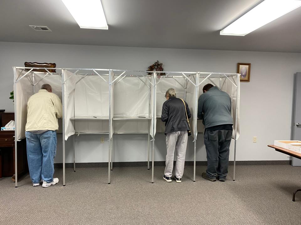 Three of Franklin County’s 98,717 registered voters are shown on Nov. 7 in the voting booths at Greencastle Church of the Brethren.