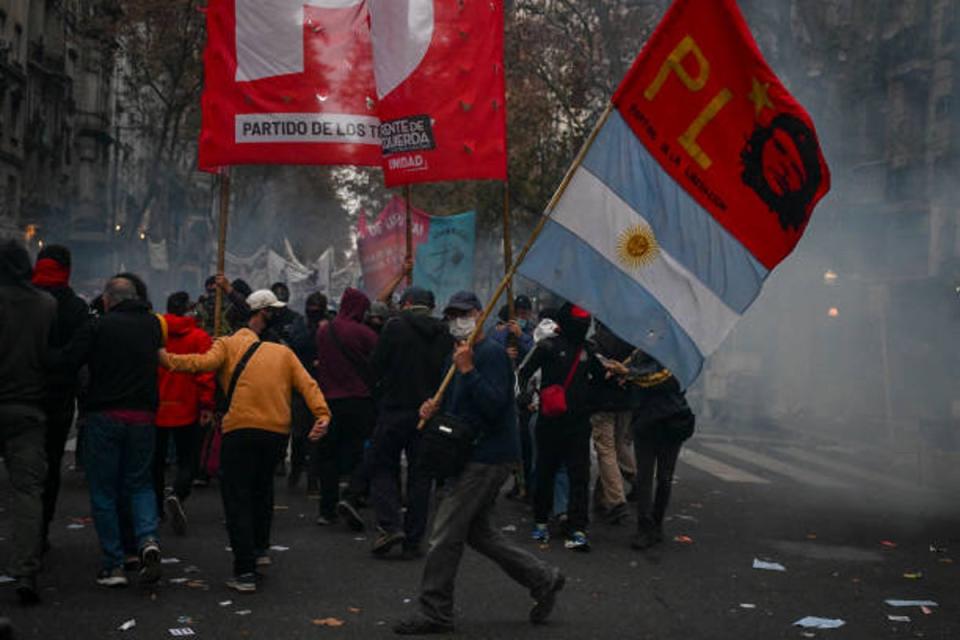 Demonstrators march during a protest near the National Congress in Buenos Aires on 12 June 2024 (AFP via Getty Images)