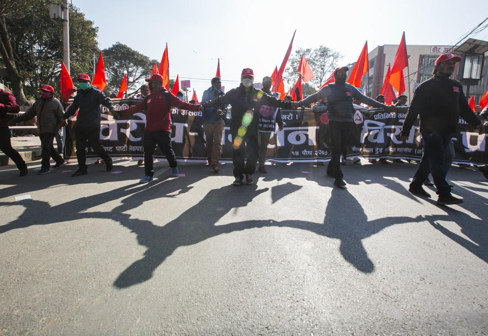 Nepalese supporters of the splinter group in the governing Nepal Communist Party participate in a protest in Kathmandu, Nepal, Tuesday, Dec. 29, 2020. Tens of thousands of supporters of the splinter group rallied in the capital on Tuesday demanding the ouster of the prime minister and the reinstatement of the Parliament he dissolved amid an escalating feud in the party. (AP Photo/Niranjan Shrestha)