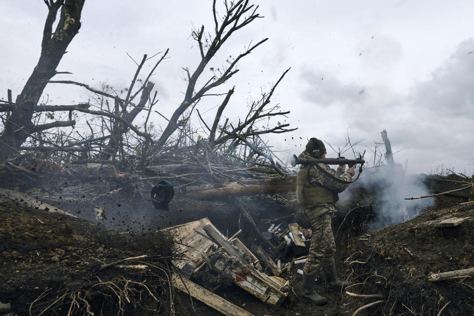 FILE - A Ukrainian soldier fires an RPG toward Russian positions at the frontline near Avdiivka, an eastern city where fierce battles against Russian forces have been taking place, in the Donetsk region, Ukraine, on April 28, 2023. Two years after Russia’s full-scale invasion captured nearly a quarter of the country, the stakes could not be higher for Kyiv. After a string of victories in the first year of the war, fortunes have turned for the Ukrainian military, which is dug in, outgunned and outnumbered against a more powerful opponent. (AP Photo/Libkos, File)