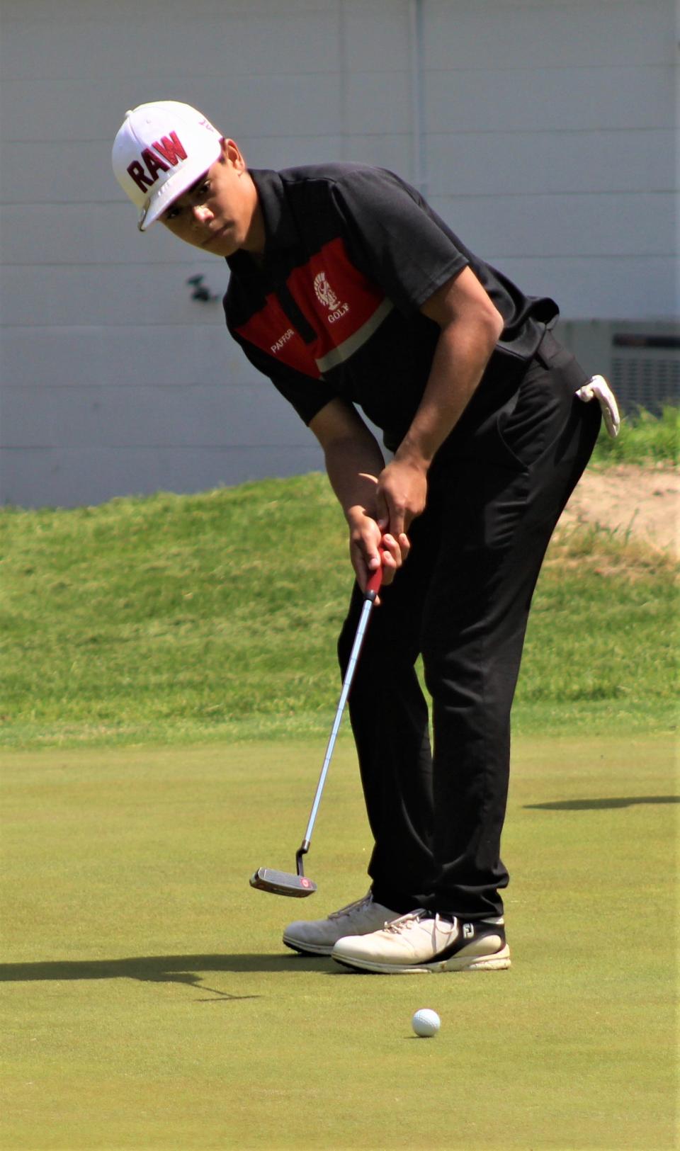 Monroe's Kyle Pafford hits a putt on the 18th green during the Monroe County Championship Monday.