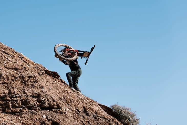 Sam Soriano hikes up to session her line on the first of three ride days.