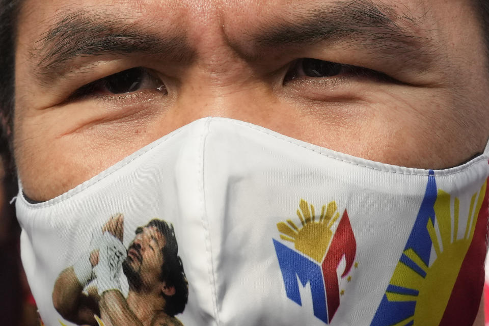 Retired Filipino boxing star and senator Manny Pacquiao wears a mask to prevent the spread of the coronavirus before filing his certificate of candidacy for next year's presidential elections at the Commission on Elections on Friday, Oct. 1, 2021 in Manila, Philippines. Friday marks the start of a weeklong registration period for candidates seeking to lead a Southeast Asian nation that has been hit hard by the pandemic and deep political conflicts. (AP Photo/Aaron Favila)