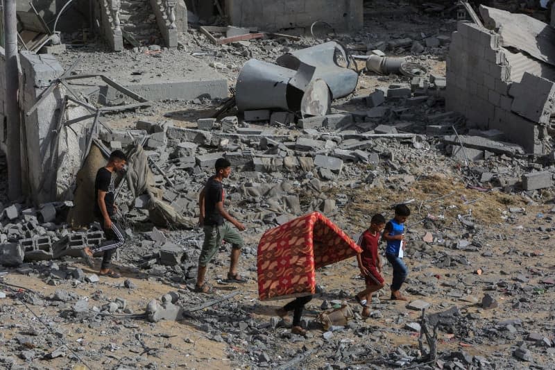 Palestinians inspect damaged houses after Israeli warplanes bombed a home for the Al-Shaer family, leading to widespread destruction in the Al-Salam neighbourhood, east of the city of Rafah, in the southern Gaza Strip. Abed Rahim Khatib/dpa