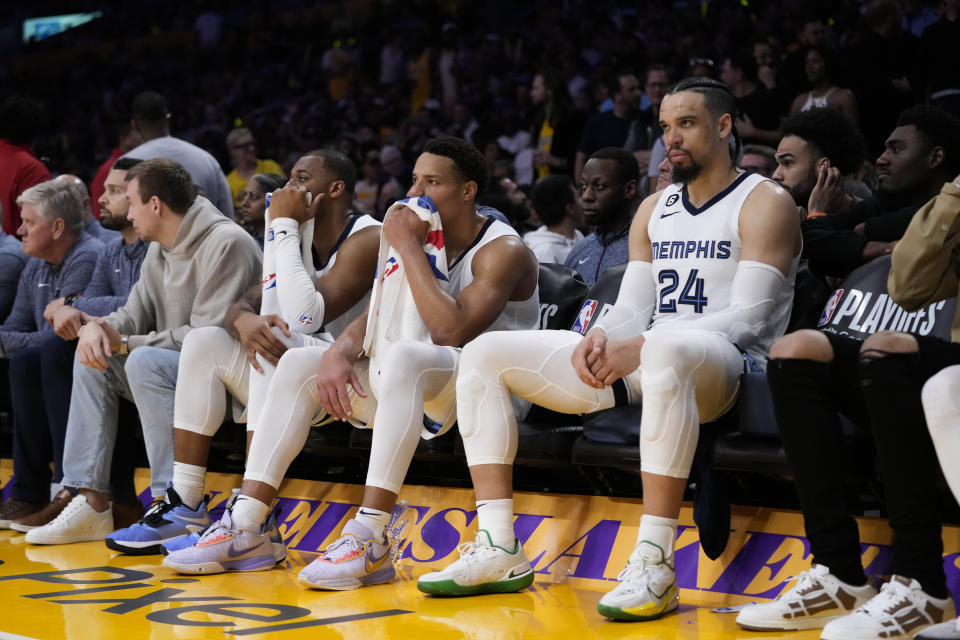 Memphis Grizzlies' Dillon Brooks, Desmond Bane and Xavier Tillman, from right, watch from the bench during the second half in Game 6 of the team's first-round NBA basketball playoff series against the Los Angeles Lakers Friday, April 28, 2023, in Los Angeles. The Lakers won 125-85. (AP Photo/Jae C. Hong)