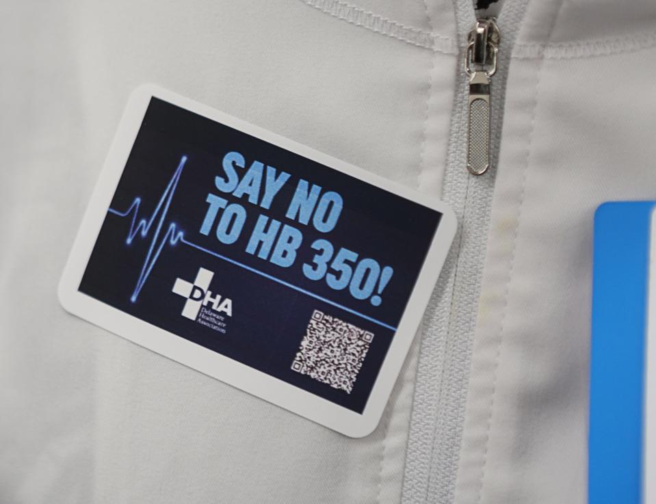 A healthcare worker sports a sticker against House Bill 350 at Legislative Hall in Dover on Wednesday, March 27, 2024.