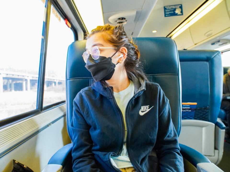 The author looks out the window of a train in a first-class car