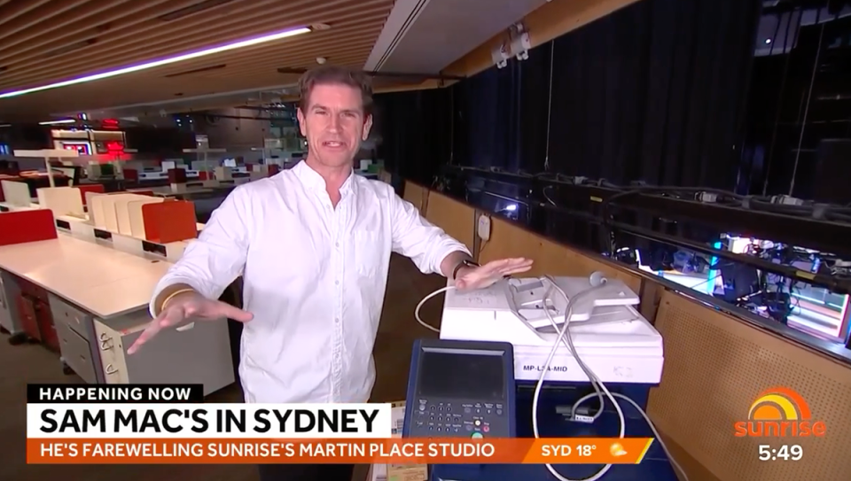 Sunrise’s Sam Mac standing next to a printer.