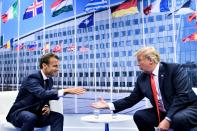 <p>French President Emmanuel Macron and President Trump shake hands before their bilateral meeting on the sidelines of the NATO summit in Brussels on July 11, 2018. (Photo: Brendan Smialowski/ AFP/Getty Images) </p>