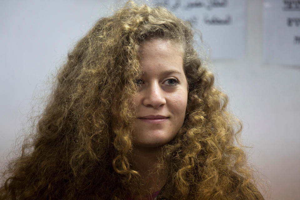 FILE - In this Tuesday, Feb. 13, 2018 file photo, Palestinian activist Ahed Tamimi stands inside the Ofer military prison near Jerusalem. When Israel locked up Ahed Tamimi for slapping a soldier last year, it hoped to finally silence the teenage Palestinian activist. Instead, it created an international celebrity. (AP Photo/Ariel Schalit, File)