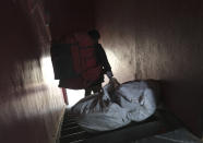 An Amazon delivery person drags a bag containing packages as he steps out from his office to make deliveries, in Kohima, capital of the northeastern Indian state of Nagaland, Friday, May 29, 2020. India’s economic growth will fall to 4.2% in financial year 2019-20 as compared to 6.1% in the previous year and likely to contract this year because of the coronavirus pandemic. Millions of workers have fled cities after losing their jobs as authorities imposed the lockdown in March and started easing it early this month to promote economic activity. (AP Photo/Yirmiyan Arthur)