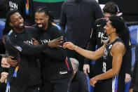 Brooklyn Nets players, from left, Jeff Green, DeAndre Jordan and Spencer Dinwiddie celebrate after the team's win over the Boston Celtics during an NBA basketball game Friday, Dec. 25, 2020, in Boston. (AP Photo/Michael Dwyer)