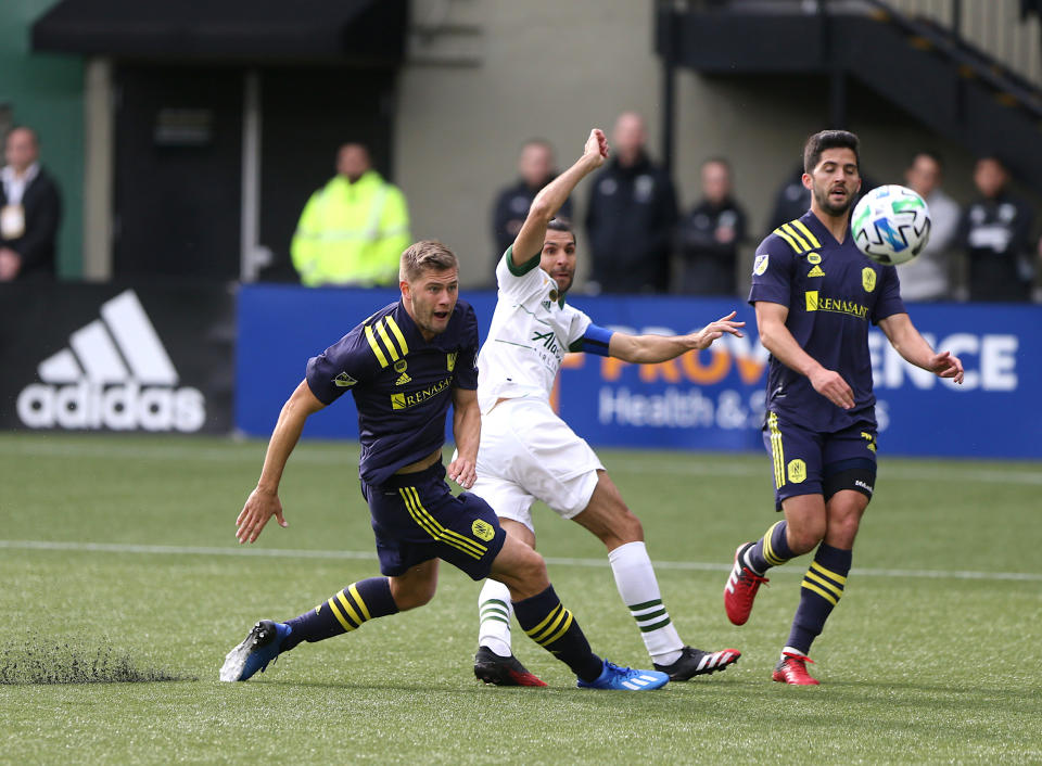 Portland Timbers' Diego Valeri, center, shoots for a goal against Nashville SC in an MLS soccer match in Portland, Ore., Sunday, March 8, 2020. (Sean Meagher/The Oregonian via AP)