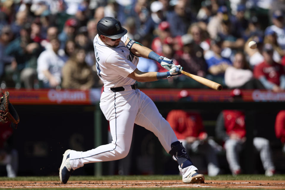 Seattle Mariners catcher Cal Raleigh hits a solo home run off a pitch from Cincinnati Reds pitcher Andrew Abbott during the second inning of a baseball game, Wednesday, April 17, 2024, in Seattle. (AP Photo/John Froschauer)