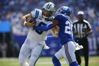 New York Giants' Julian Love, right, tries to tackle Carolina Panthers quarterback Baker Mayfield during the first half an NFL football game, Sunday, Sept. 18, 2022, in East Rutherford, N.J. (AP Photo/John Munson)