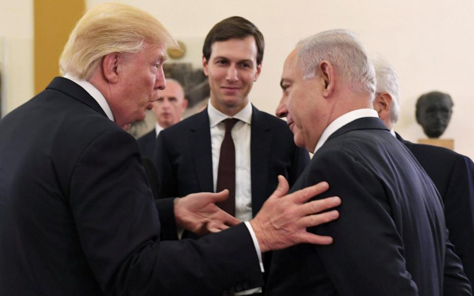 Donald Trump speaks with Benjamin Netanyahu while his son-in-law Jared Kushner looks on - Credit: Government Press Office