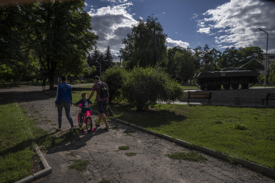 Parents Dmytro Roslyakov, and Karyna Ponomarenko, walk with their 5-year-old daughter Anhelina, in a park as air raids go off, in Kramatorsk, eastern Ukraine, Thursday, July 14, 2022. It’s well known that many of the residents of eastern Ukraine who refuse to heed authorities’ calls to flee are older ones. It’s jarring, then, to explore the streets of communities close to the front line and spot children. Unlike the adults who decide to stay, the children have their fate tied to the wishes of their parents. (AP Photo/Nariman El-Mofty)
