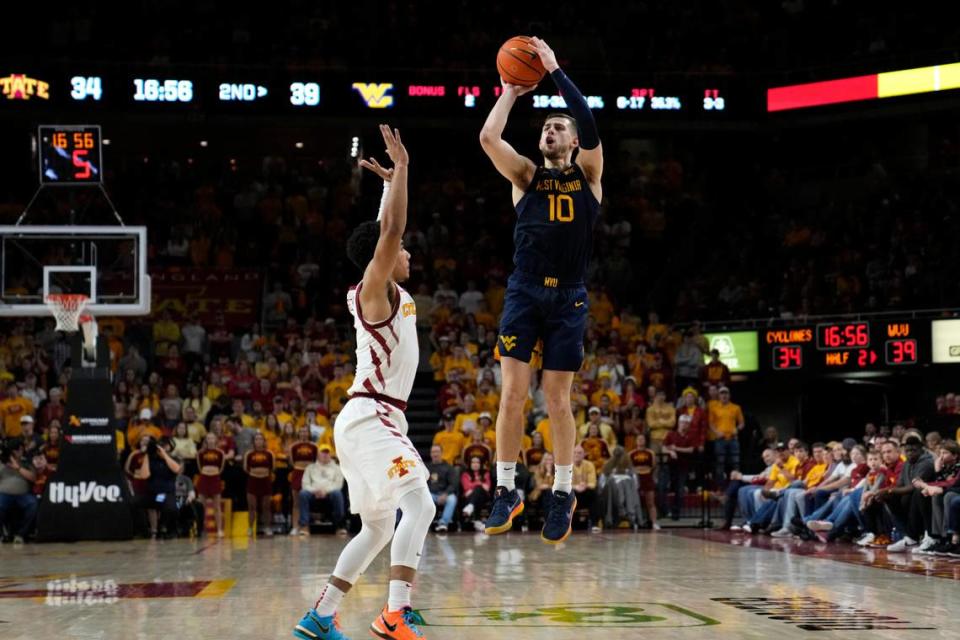 West Virginia guard Erik Stevenson (10) shoots over Iowa State guard Tamin Lipsey during the second half of an NCAA college basketball game, Monday, Feb. 27, 2023, in Ames, Iowa. (AP Photo/Charlie Neibergall)