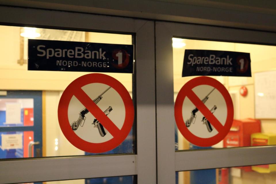 Signs prohibiting customers from carrying guns at the bank in Longyearbyen (George Godson)