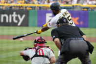 Pittsburgh Pirates' Gregory Polanco, top right, singles off Philadelphia Phillies starting pitcher Vince Velasquez, driving in a run, during the first inning of a baseball game in Pittsburgh, Friday, July 30, 2021. (AP Photo/Gene J. Puskar)