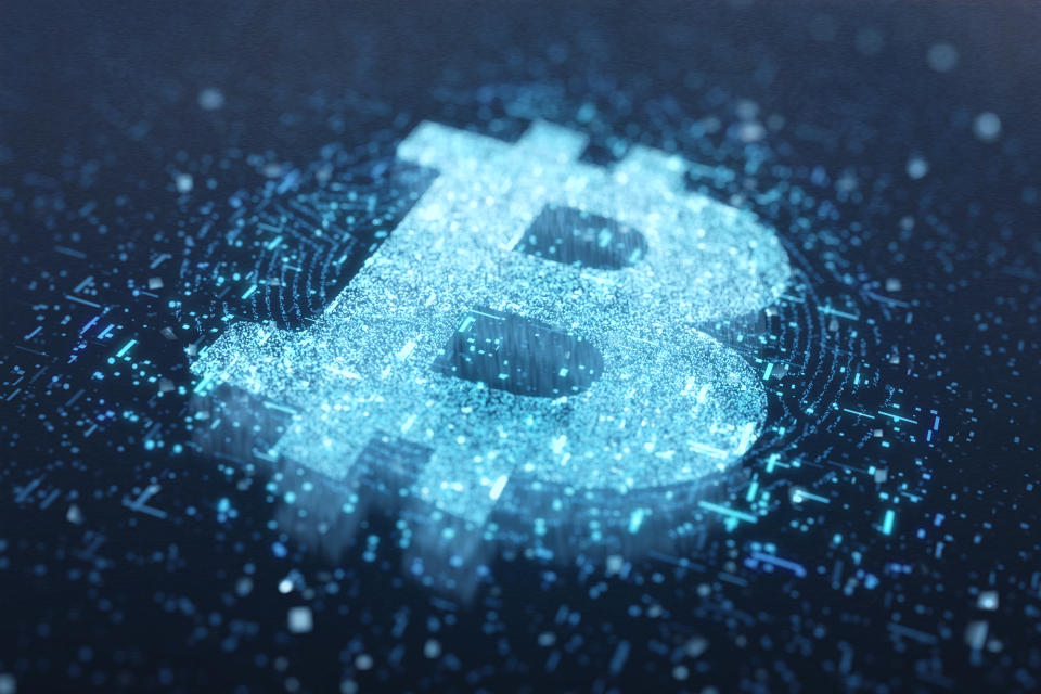 Abstract Bitcoin logo by a glowing particle on technology dark background.