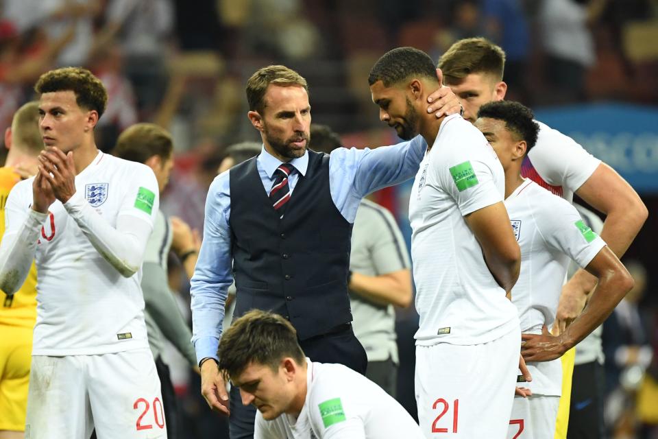 England manager Gareth Southgate consoles one of his many young players, Ruben Loftus-Cheek, after his team’s 2-1 World Cup semifinal loss to Croatia. (Getty)