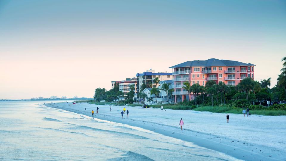 Sunrise brings beach walkers to Fort Myers Beach located on Estero Island along the Gulf of Mexico.