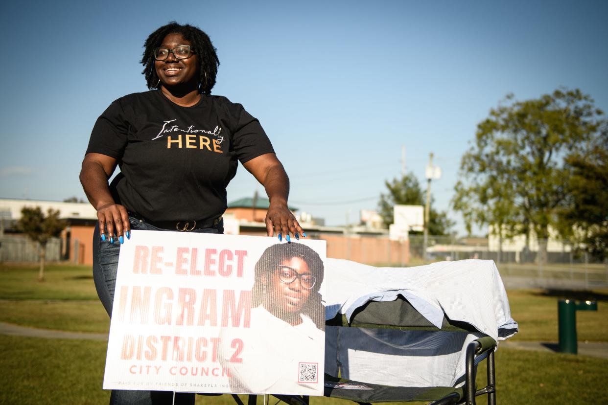 District 2 council member Shakeyla Ingram puts up a campaign sign while campaigning outside the polling site at Fayetteville Fire Station 1 on Tuesday, Oct. 10, 2023.