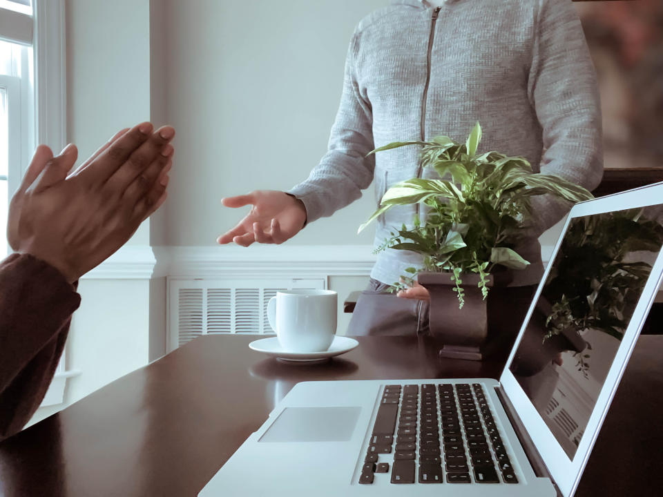 two people talking over a computer