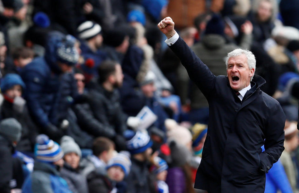 Mark Hughes made a winning start as Southampton manager with a 2-0 victory at Wigan.