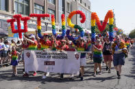 A group representing Indiana University School of Medicine walks down the route during the Pride Parade, Saturday, June 10, 2023, in Indianapolis. (AP Photo/Darron Cummings)