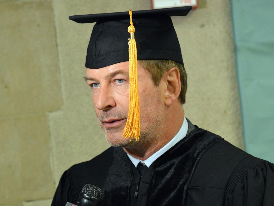 Alec Baldwin wearing a graduation cap and gown upon receiving his honorary doctorate