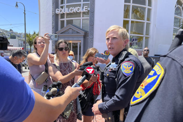 San Francisco Police Officer spokesperson Kathryn Winters speaks with reporters outside the entrance to the Castro Muni station following a shooting in San Francisco, Wednesday, June 22, 2022. (AP Photo/Janie Har)
