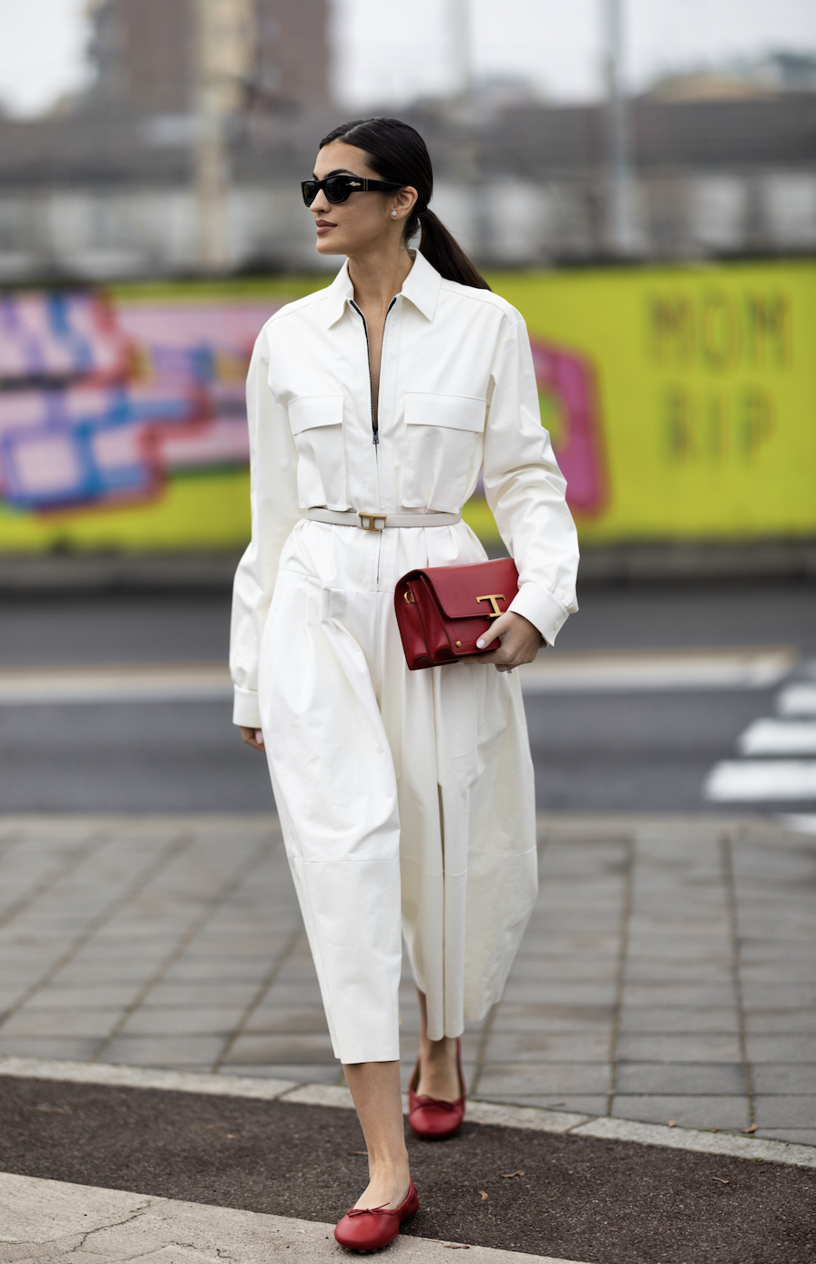 woman in white jumpsuit and red ballet flats