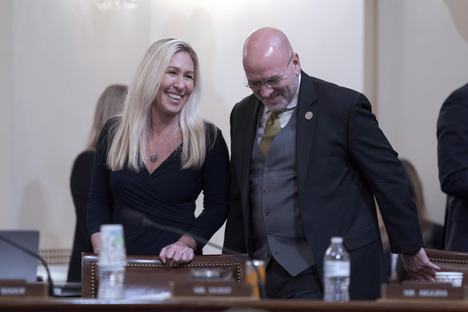 Rep. Marjorie Taylor Greene, R-Ga., left, and Rep. Clay Higgins, R-La., confer during a break as Republicans on the House Homeland Security Committee move to impeach Secretary of Homeland Security Alejandro Mayorkas over the crisis at the U.S.-Mexico border, at the Capitol in Washington, Tuesday, Jan. 30, 2024. (AP Photo/J. Scott Applewhite)