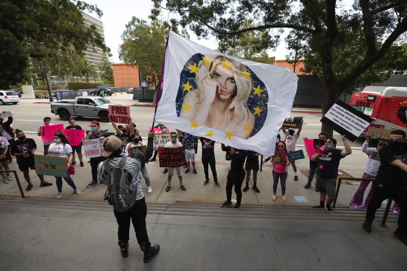 A supporter waves a flag during a rally for pop star Britney Spears during a conservatorship case hearing at Stanley Mosk Courthouse in Los Angeles