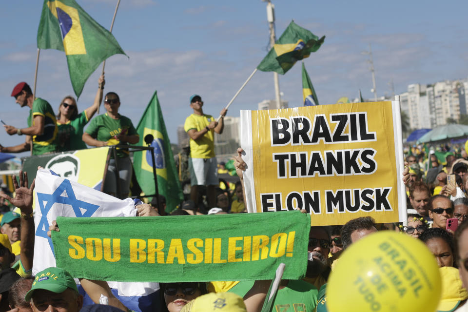 Simpatizantes del expresidente brasileño Jair Bolsonaro participan en un mitin para exigir libertad de expresión, luego de que el Supremo Tribunal Federal ordenara suspender ciertas cuentas en la red social X, el domingo 21 de abril de 2024, en la playa Copacabana, en Río de Janeiro, Brasil. El letrero en primer plano dice: "Soy brasileño", y el que está a la derecha señala: "Brasil le agradece a Elon Musk". (AP Foto/Bruna Prado)