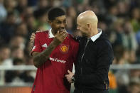 Manchester United's Marcus Rashford speaks to Manchester United's head coach Erik ten Hag after being substituted during the Europa League round of 16 second leg soccer match between Real Betis and Manchester United at the Benito Villamarin stadium in Seville, Spain, Thursday, March 16, 2023. (AP Photo/Jose Breton)