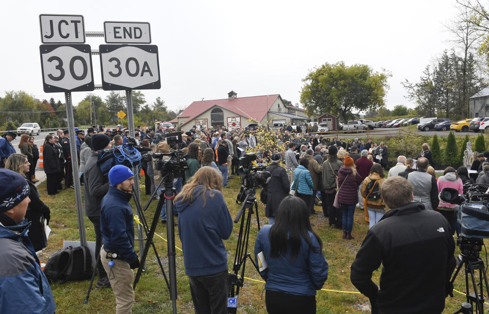 Family members and friends gather with first responders at the Reflections Memorial for a memorial unveiling ceremony, on the one year anniversary of the Schoharie limousine crash that killed 20 people next to the Apple Barrel Restaurant Saturday, Oct. 5, 2019, in Schoharie, N.Y. (AP Photo/Hans Pennink)