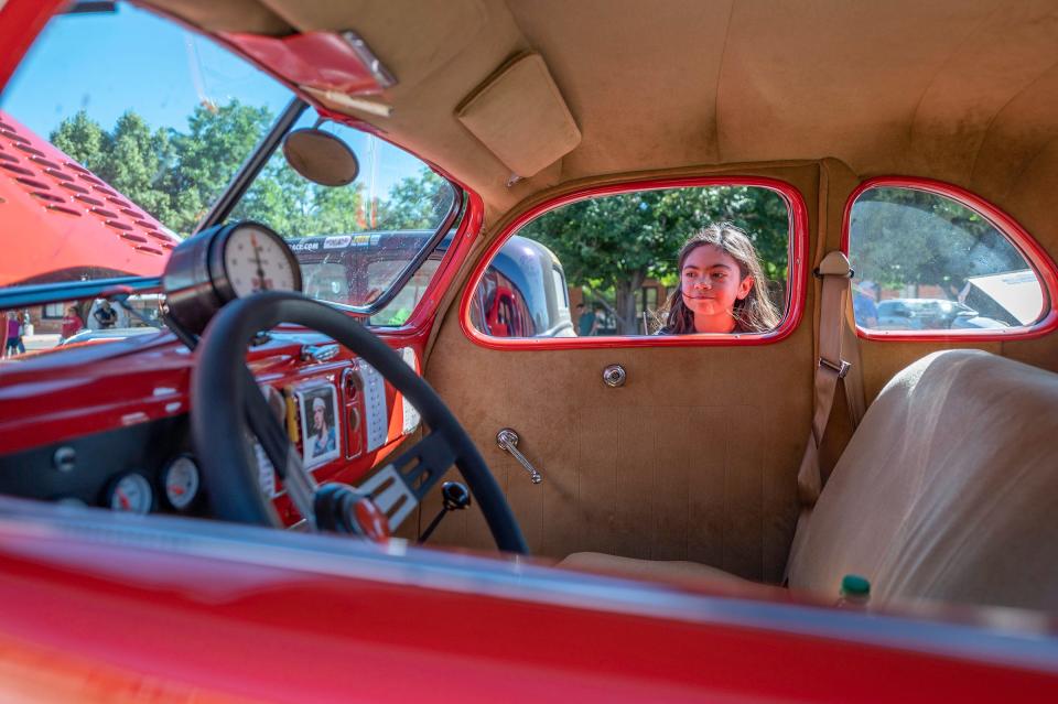 Mercedez Jimenez, 10, looks at the interior of a vehicle at the 2023 Hemmings Motor News Great Race stop in Pueblo on Saturday.